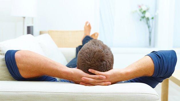 Portrait of male resting at home on his couch